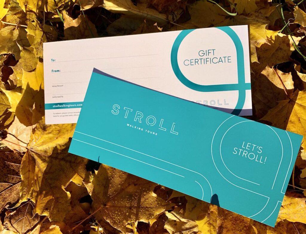 Stroll gift certificates on a bed of yellow fall leaves in the autumn sun.