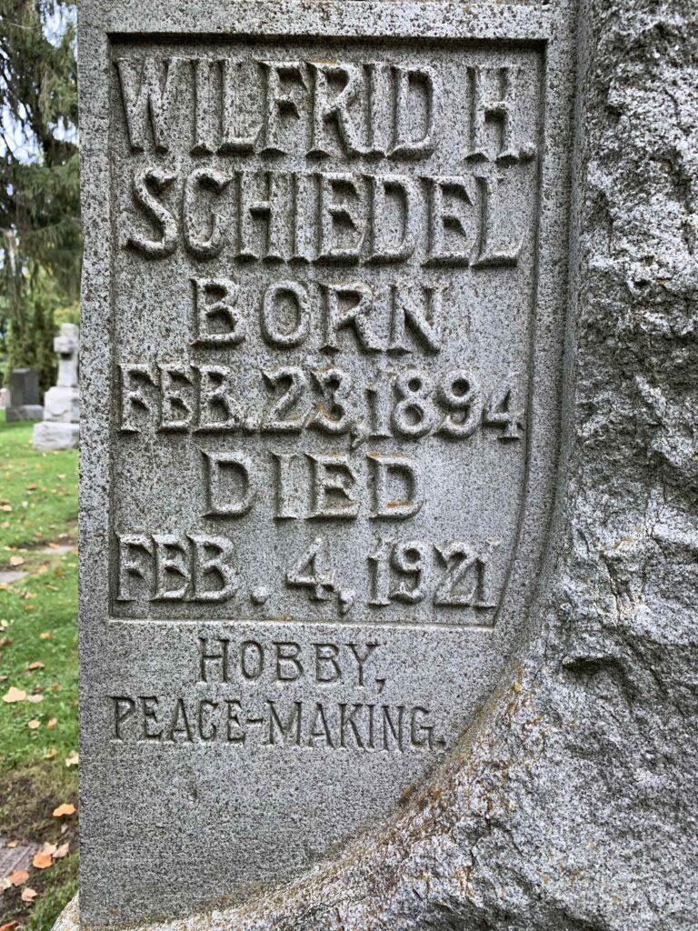 Grave marker in Mount Hope Cemetery, Kitchener, for Wilfried H. Schiedel b. Feb 23, 1894, d. Feb 4, 1921, age 27. A hobby of 'Peace-making' is carved below his name and dates.