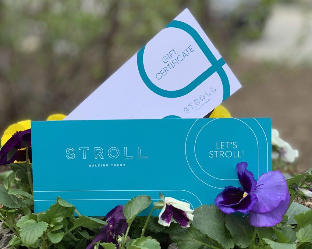 Stroll Gift Certificates displayed in a box of spring pansy flowers