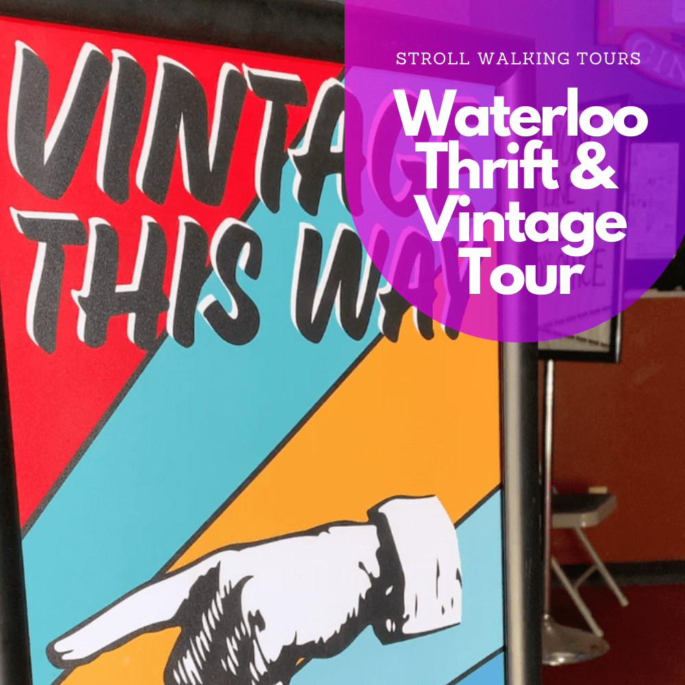 a red blue and yellow sign says "Vintage This Way" with a hand pointing to the left side.
