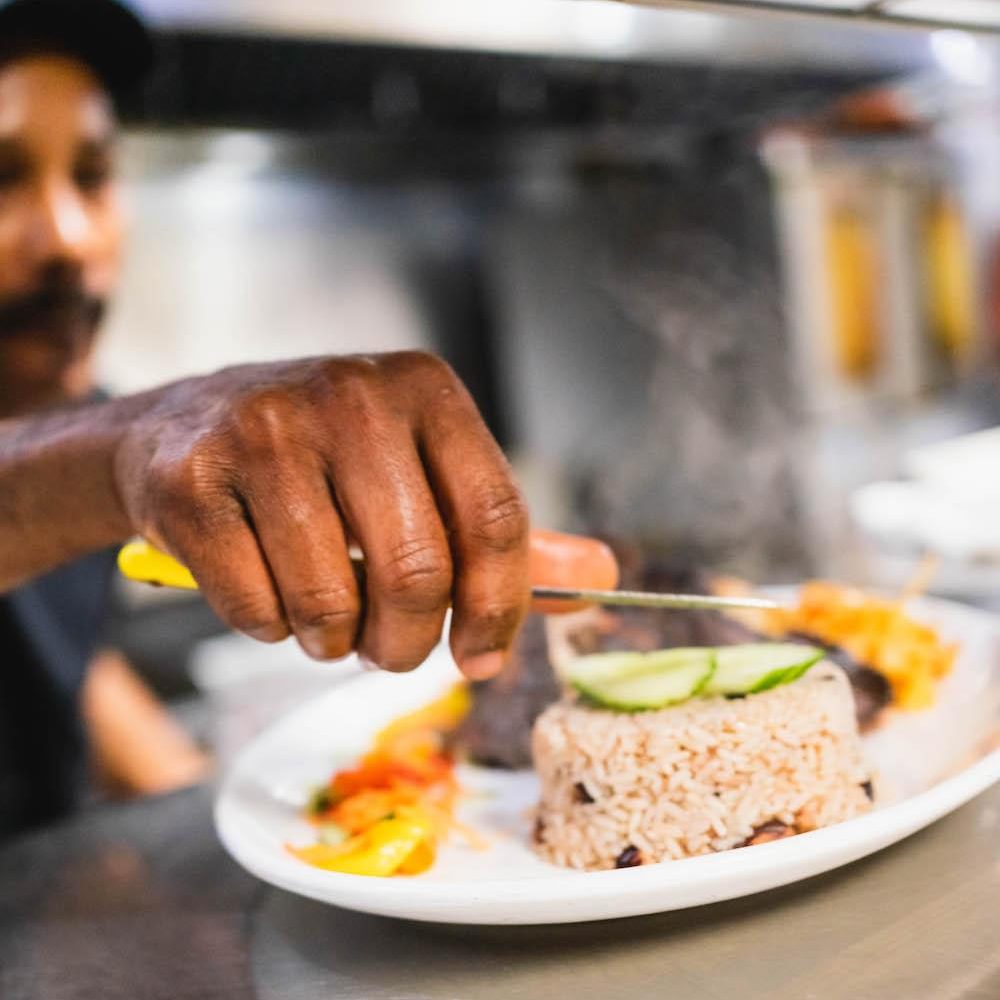 Food being placed on a place in a restaurant kitchen window