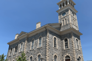a view of the old stone Galt town hall against a bright blue summer sky.