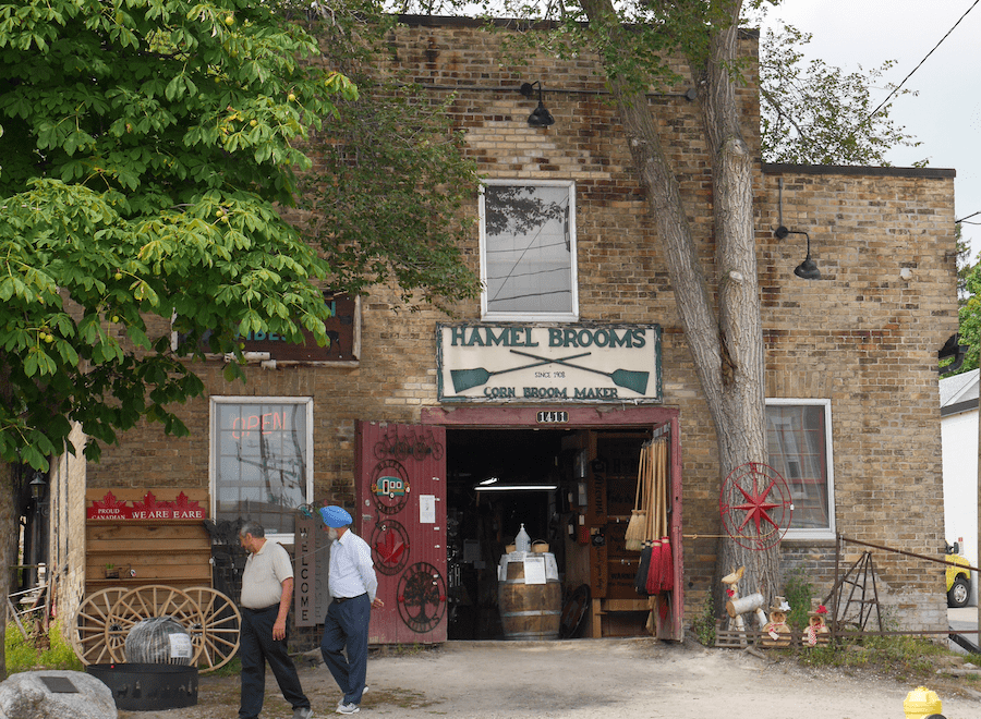 Two men in front of Hamel Brooms, on walking tour in St. Jacobs