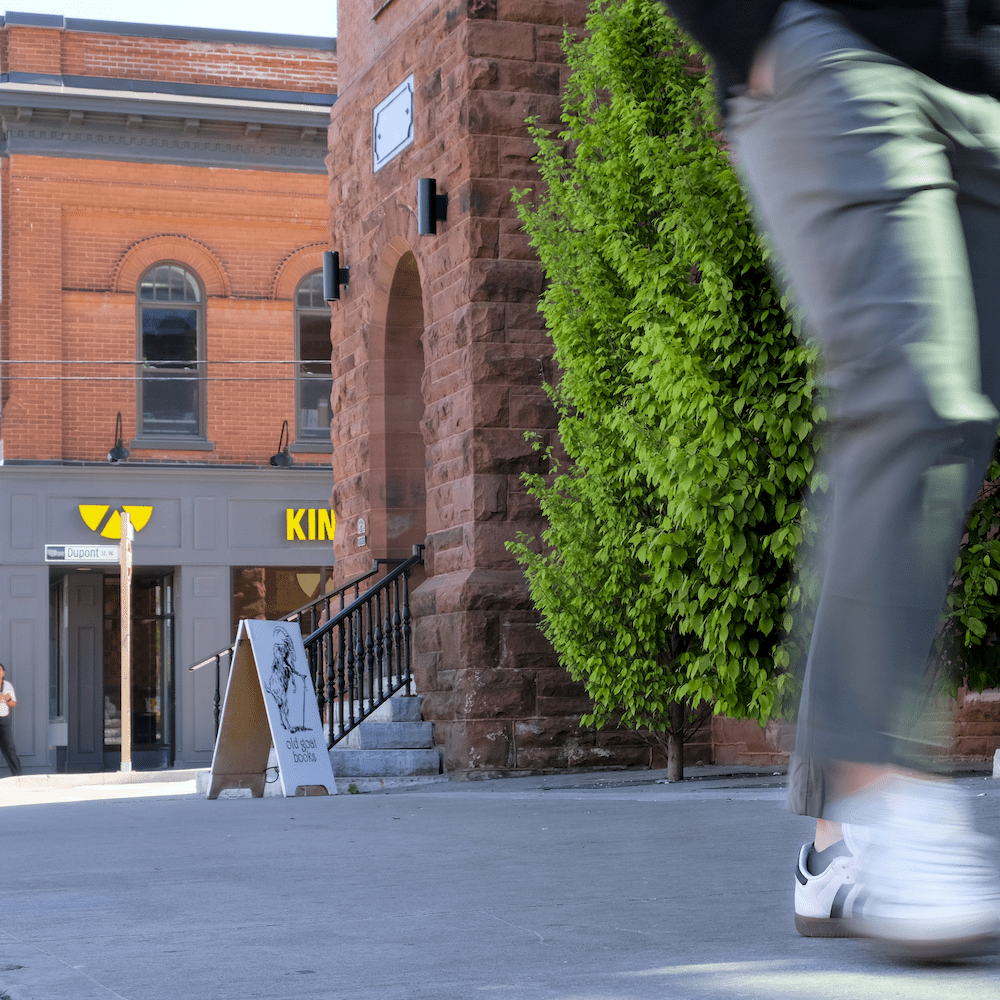 Waterloo Architecture Tour a pair of legs walk past the former post office in Uptown Waterloo
